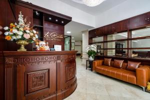 a lobby with a couch and flowers in a store at La Bonita Hotel and Apartments in Ho Chi Minh City