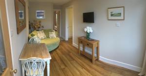 a living room with a couch and a table at Seaside Stay in Rustington