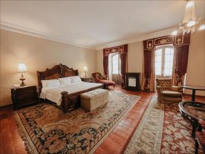 a bedroom with a bed and a living room at Parador Santa Maria La Real in Sucre