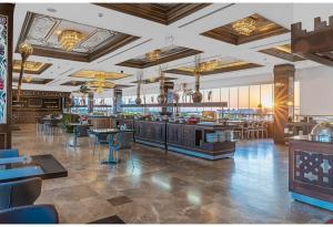 ein Restaurant mit einer Bar sowie Tischen und Stühlen in der Unterkunft Savoy Hotel Spa & Casino in Kyrenia