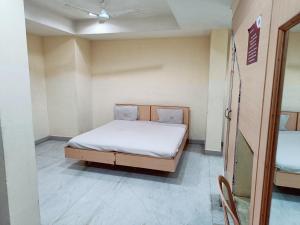 a small bedroom with a bed in a room at Hotel Chanma International in Coimbatore