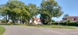 an empty road with trees and a house in the background at Chambre cosy entre mer et montagne in Ascain