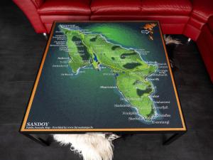 a map of the united kingdom on a couch at Luxurious cabin / 3 BR / Scenic village in Skálavík
