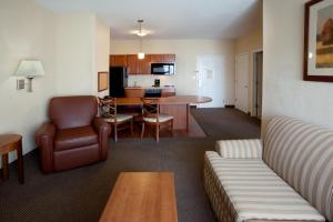 a living room with a couch and a table at Candlewood Suites Corpus Christi-SPID, an IHG Hotel in Corpus Christi