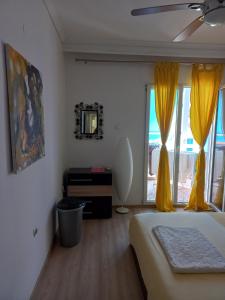 a bedroom with a bed and a window with yellow curtains at Perea Silvi suite in Perea