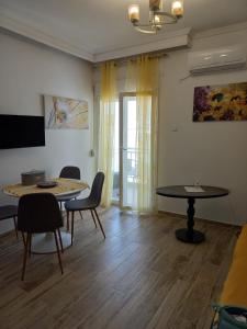 a living room with two tables and chairs and a tv at Perea Silvi suite in Perea