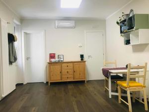 a living room with a table and a dining room at Donna Flor casa vacanze in Barletta