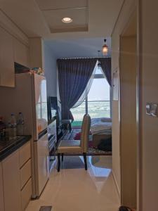 a bedroom with a window with a bed and a chair at Heaven Escape surrounded by stunning golf view High floor -Netflix-GYM-pool -perfect vacations in Dubai