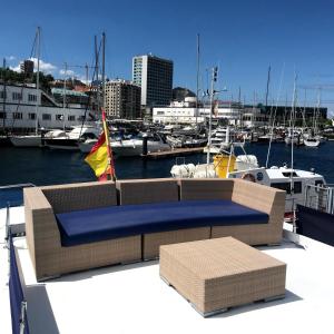 a couch on the back of a boat in a harbor at Don Maximo in Vigo