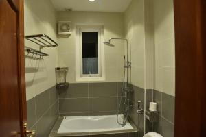 a bathroom with a shower and a bath tub at Đà Lạt Villa 84 Hồ Xuân Hương in Da Lat +67 photos
