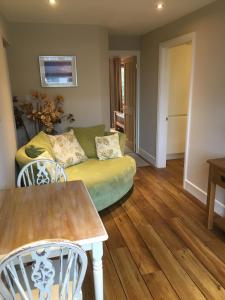a living room with a couch and a table at Seaside Stay in Rustington