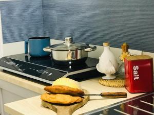 a kitchen counter with some food on a table at Donna Flor casa vacanze in Barletta +4 photos