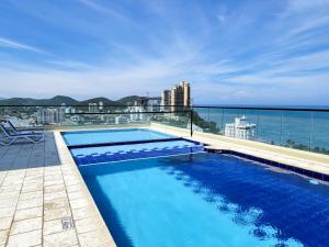 a swimming pool on the roof of a building at Apartasuites VITA 945 RODADERO - By Bedviajes in Santa Marta