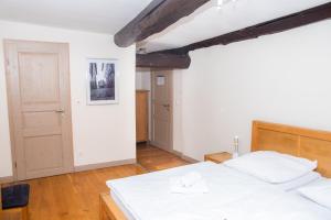a bedroom with a large white bed with a wooden headboard at Alte Windmühle - Hotel Garni in Hannoversch Münden
