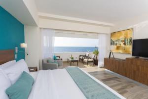 a bedroom with a bed and a view of the ocean at Gamma Campeche Malecon in Campeche