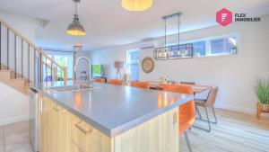 a kitchen with a counter top and a dining room at La Villa Éden-SPA de Portneuf / Relaxation and activities aplenty in Pont-Rouge