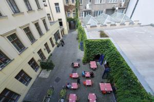 an overhead view of a courtyard in a building with tables at Duplex Apartment in Prague