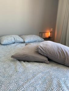 a bed with two pillows on it in a bedroom at Studio Antwerp Central Station in Antwerp