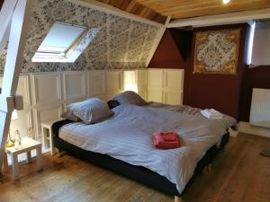 a bedroom with a bed with a red bag on it at Ostend BackPackers Lodge in Ostend