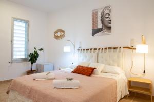 um quarto com uma cama grande com duas toalhas em AldeaMia, Forest, mountain view, beach at 8 min em Vilanova de Escornalbou
