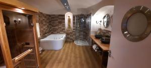 a bathroom with a tub and a sink and a mirror at Excellent Romantic in Prague +21 photos
