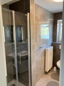 y baño con ducha y lavamanos. en Ferienwohnung Winkler en Augsburg