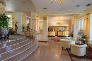 a large room with a large staircase leading to a balcony at Hotel Astoria in Stresa