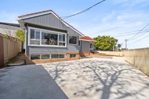 a house with a large window on a driveway at New 2 Bedroom House 500m to Mall with Free Parking in Bankstown