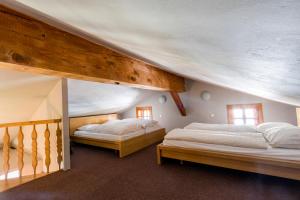 a bedroom with two beds in a room at Das Schmiedhaus in Kaprun