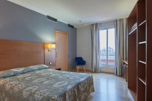 Posteľ alebo postele v izbe v ubytovaní Ramblas Hotel