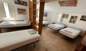 A bed or beds in a room at Masia Rural Les Alsines