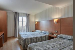 Posteľ alebo postele v izbe v ubytovaní Ramblas Hotel