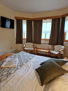 1 dormitorio con 1 cama grande y 2 sillas en Guesthouse Jelenov greben en Podčetrtek