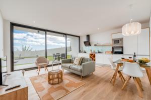 a living room with a couch and a table at Vila Inanda in Ponta do Sol