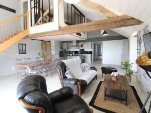 a living room with a couch and a table at "Au tour des sens " in La Jumellière