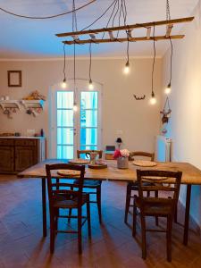 a kitchen with a large wooden table and chairs at La casa nei campi in Badia Pavese