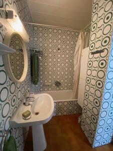 a small bathroom with a sink and a shower at Areny Arinsal hasta 6 personas in Mas de Ribafeta