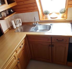 a kitchen with a sink and a counter top at Waldsee in Nagel