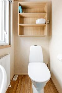 a bathroom with a white toilet and a sink at Mobile home in Sjöared in Markaryd