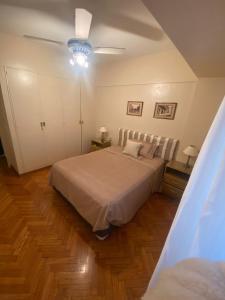 a bedroom with a bed and a ceiling fan at Mi primer logro in Buenos Aires