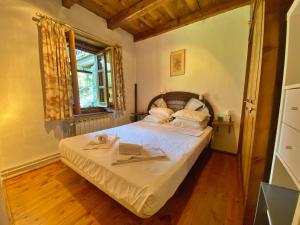 a small bedroom with a bed with a window at Pleta de Ordino 55 Casa Rústica hasta 6 personas in Ordino