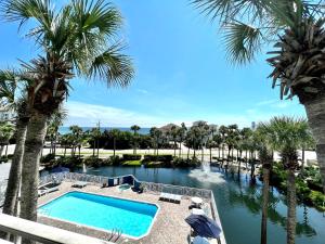 a view of the pool at the resort with palm trees at Cabana's @ Gulf Place #308 in Santa Rosa Beach