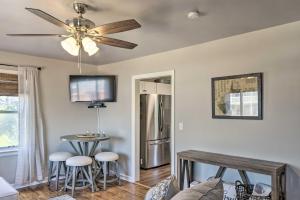 a living room with a ceiling fan and a table at Morgantown Home with Patio Near WVU Football! in Morgantown