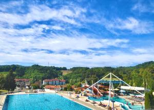 a large swimming pool with a slide in a resort at Apartments Dajčić in Varaždinske Toplice