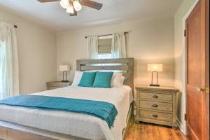 a bedroom with a bed with blue pillows and a ceiling fan at Morgantown Home with Patio Near WVU Football! in Morgantown
