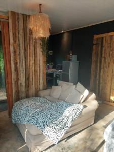 a bedroom with a white bed with a blanket at Vulture's View 8 in Hartbeespoort