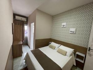 Ένα ή περισσότερα κρεβάτια σε δωμάτιο στο Hospedar Flats & Residence