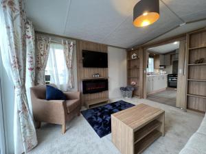 a living room with a couch and a table at Stewarts Resort Lodge 54 in St. Andrews