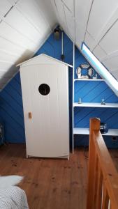 a room with a white door in a roof at KERFERNAND 