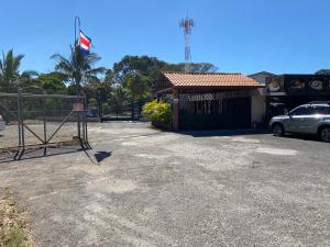 a car parked in front of a building with a gate at Apartamento H Gonzalez 14 free Parking AC wifi in Alajuela